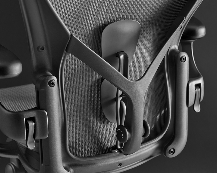 A high-back Cosm office chair with leaf arms in Nightfall dark blue, viewed from an angle.